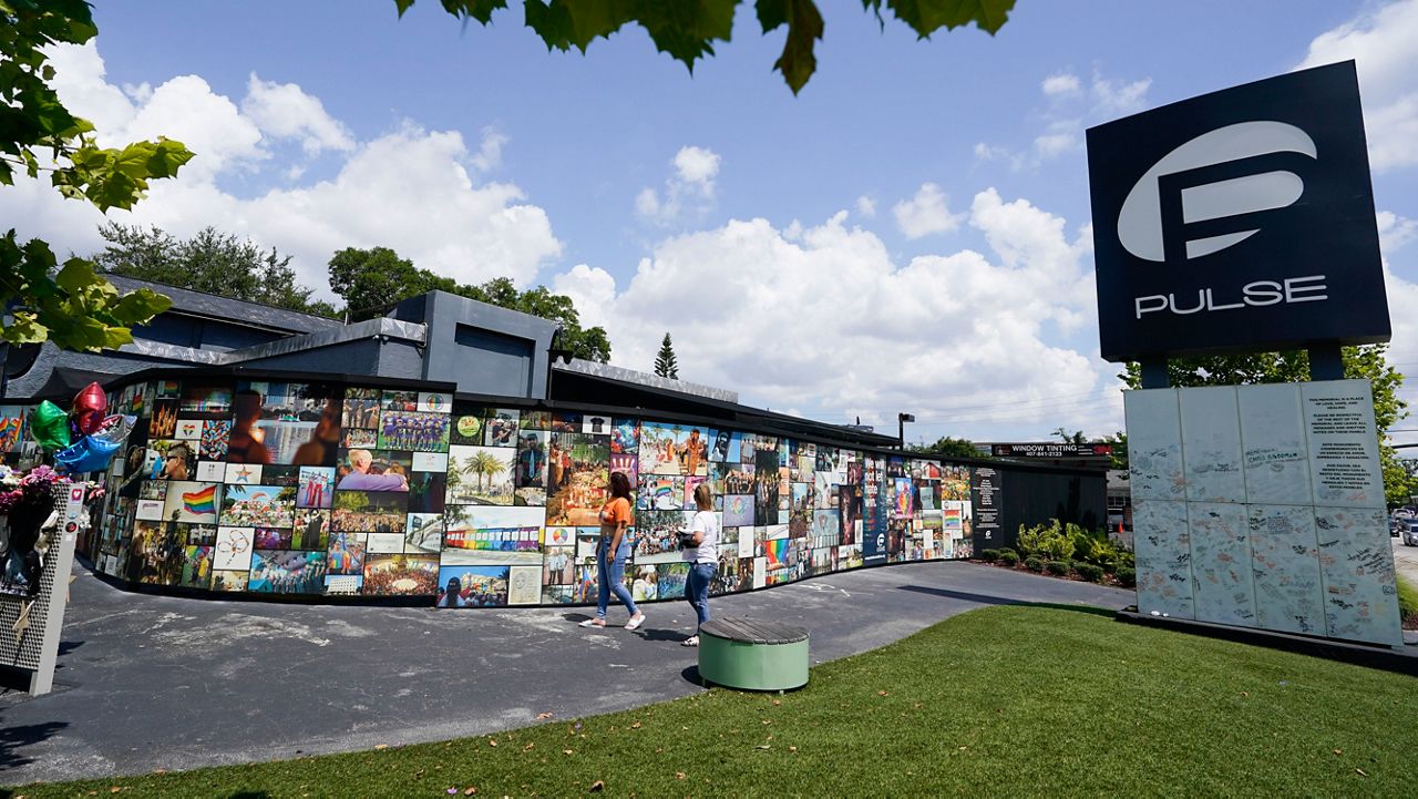 Visitors pay tribute to the display outside the Pulse nightclub memorial in Orlando, Fla. (AP Photo/John Raoux)