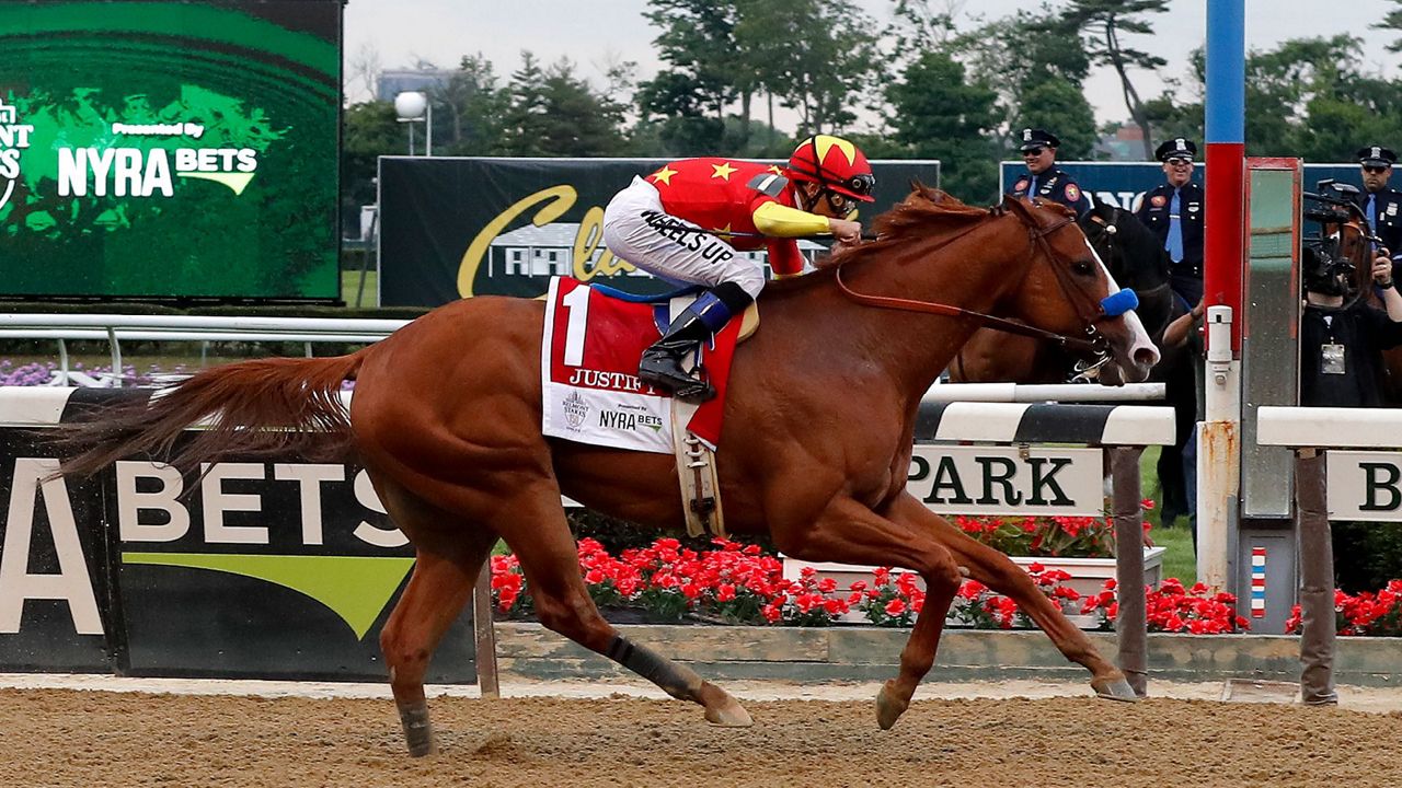 Justify, with a trainer riding on its back.