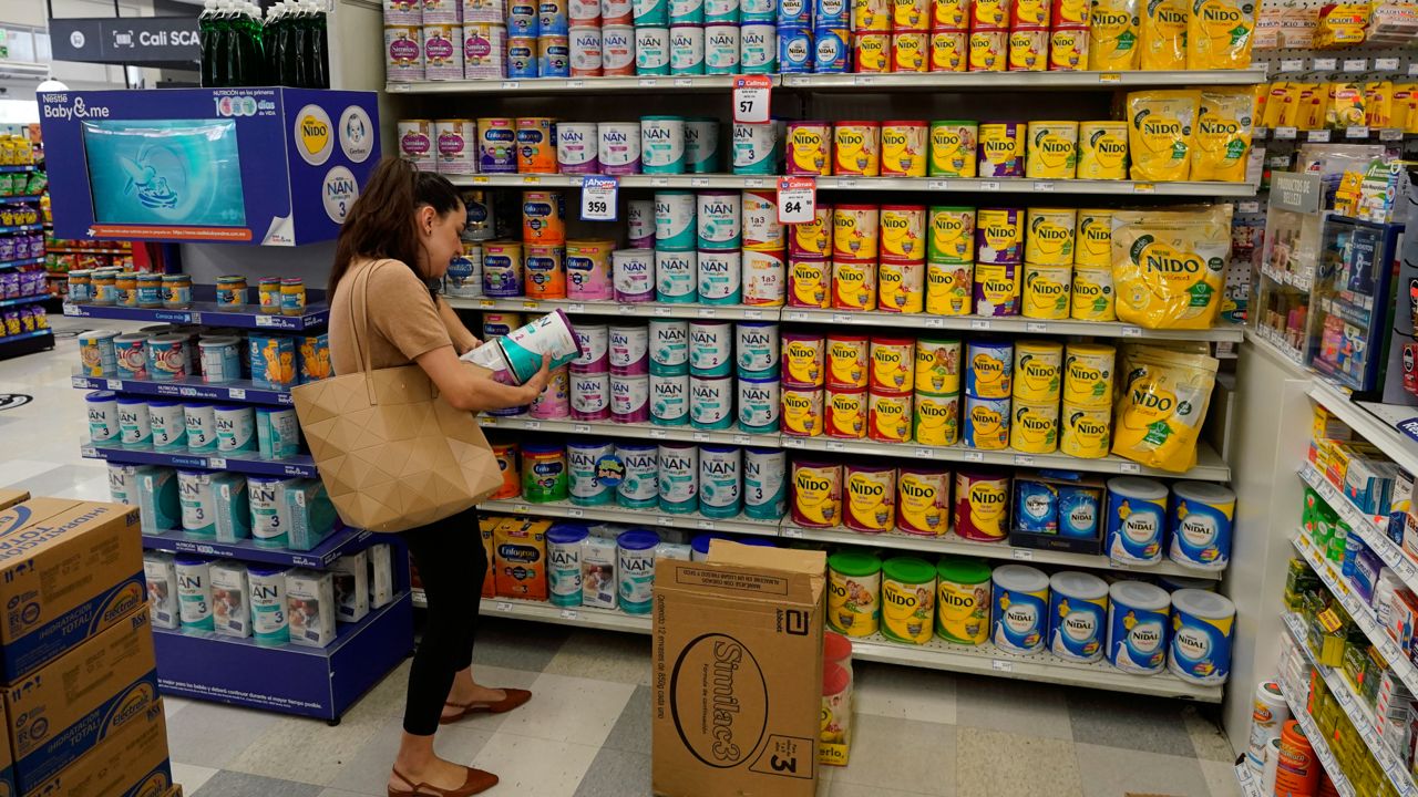 Michelle Saenz of Santee, Calif. buys baby formula at a grocery story across the border, Tuesday, May 24, 2022, in Tijuana, Mexico. (AP Photo/Gregory Bull)