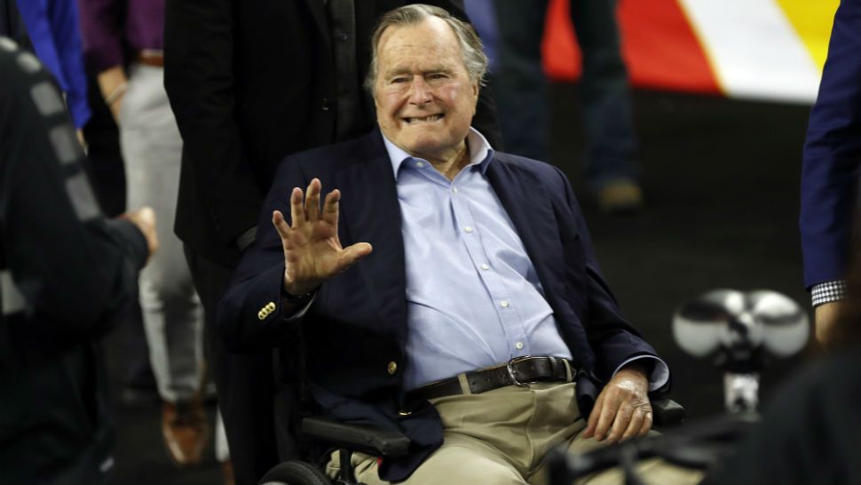 FILE - In this April 2, 2016, file photo, former President George H. W. Bush waves as he arrives at NRG Stadium before the NCAA Final Four tournament college basketball semifinal game between Villanova and Oklahoma in Houston. (AP Photo/David J. Phillip, File)