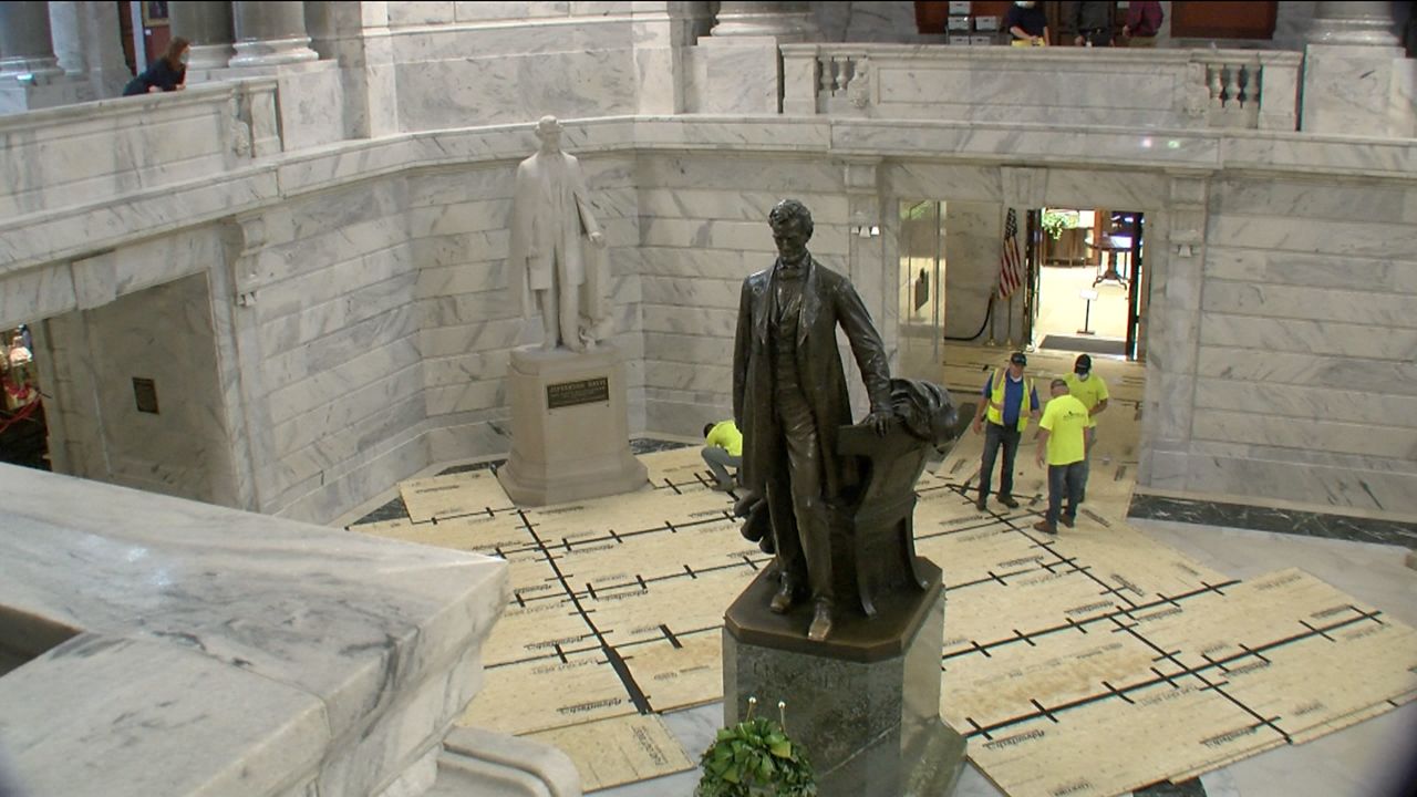 Crews prepare to take the Jefferson Davis statue out of the Capitol rotunda