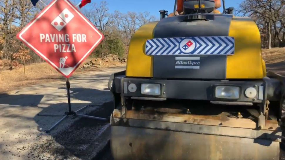 Domino's "Paving for Pizza" fixing potholes to aid the delivery of pizzas. (Courtesy: Domino's)