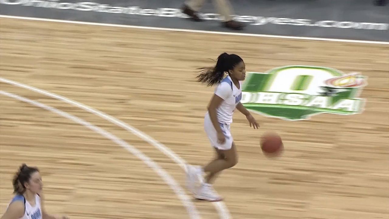 Girl playing basketball on court