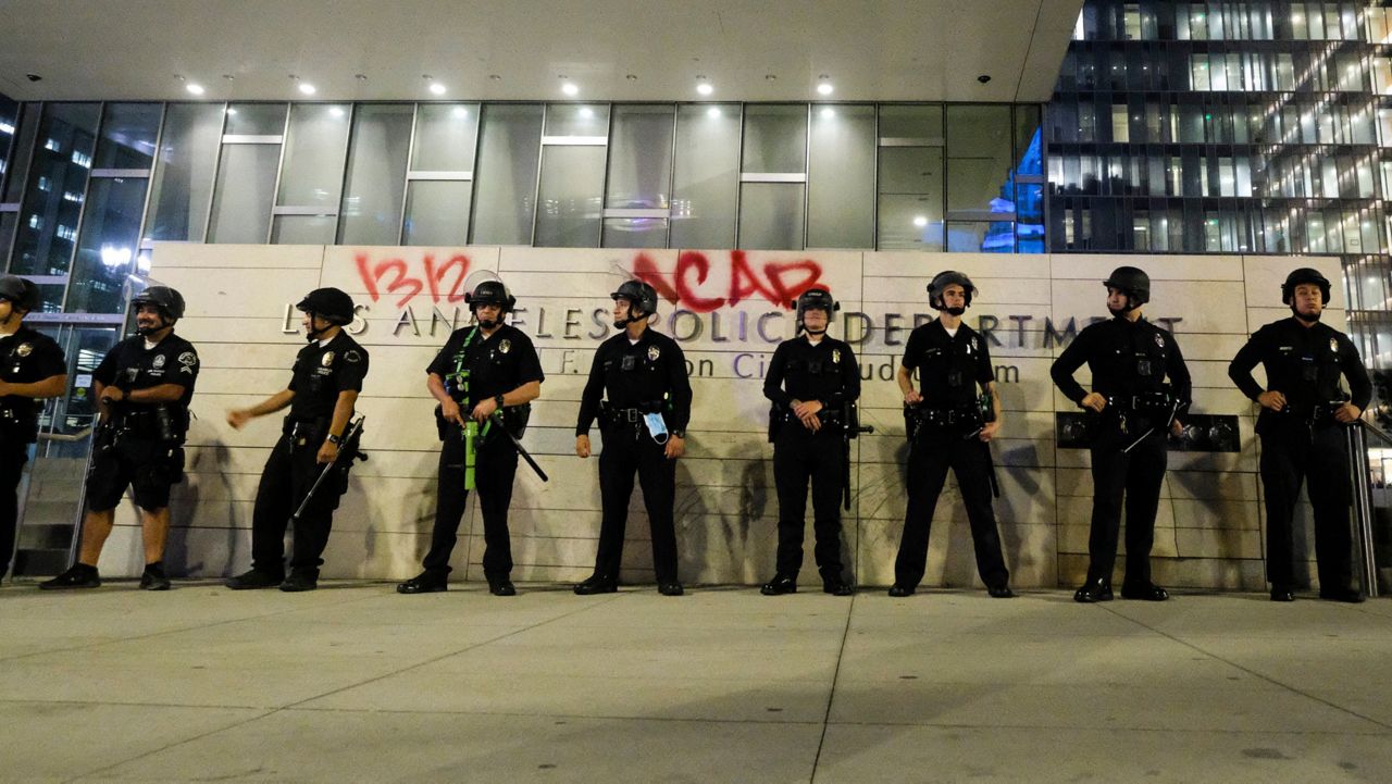 Police guard outside the LAPD headquarters during a protest of the death of George Floyd, a black man who was in police custody in Minneapolis, in downtown Los Angeles, Wednesday, May 27, 2020. (AP Photo/Ringo H.W. Chiu)