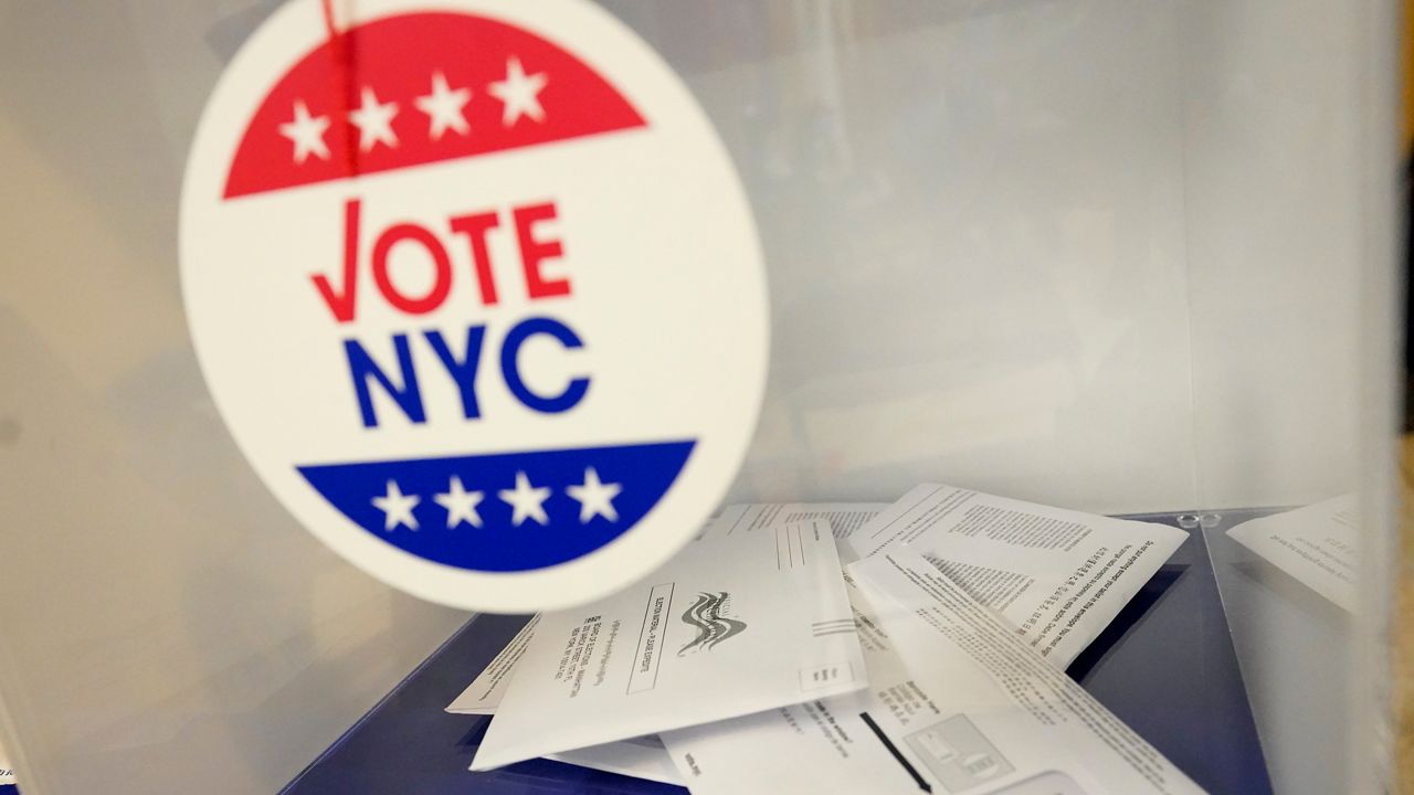 Ballots inside a clear box with a Vote NYC sticker on it.