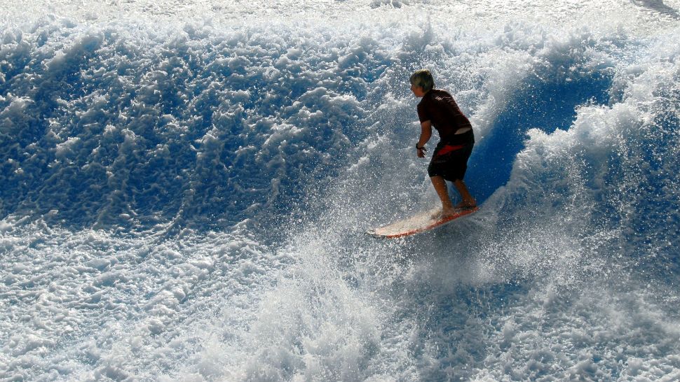 Daniel Daigle, 10, the youngest member of the Schlitterban Surf Team, rides a wave, Thursday, Aug. 9, 2007, at Schlitterbahn Water Park in South Padre Island, Texas. (AP Photo/Brad Doherty)