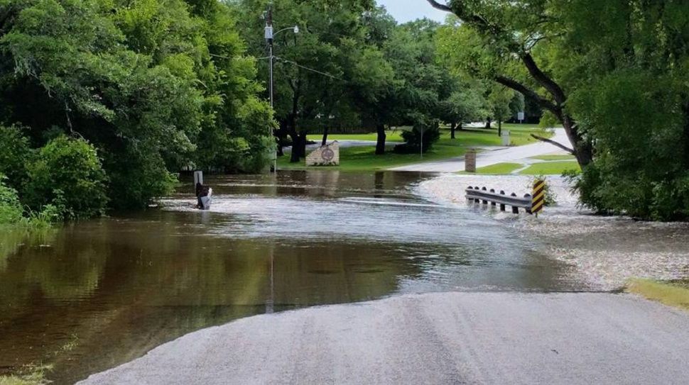 A flash flood along Geronimo Creek causes water to rise well over a roadway (Photo by Liz Aguilar, June 2015)