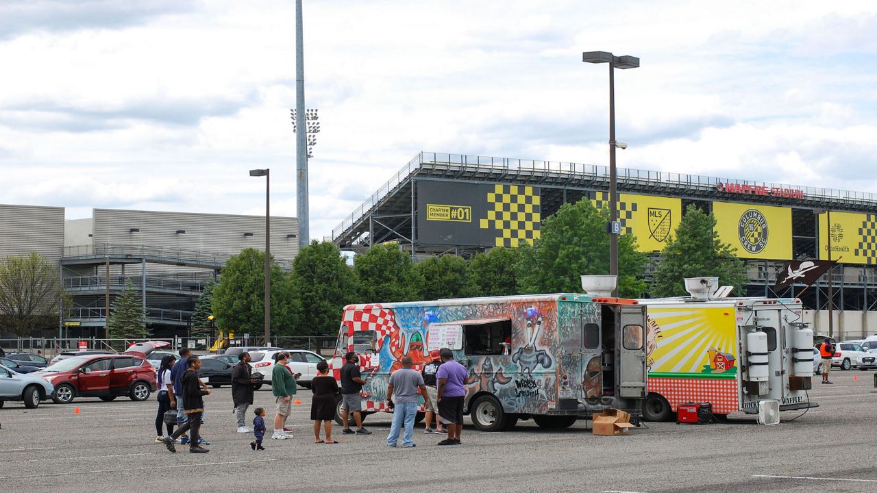 People getting food at a food truck