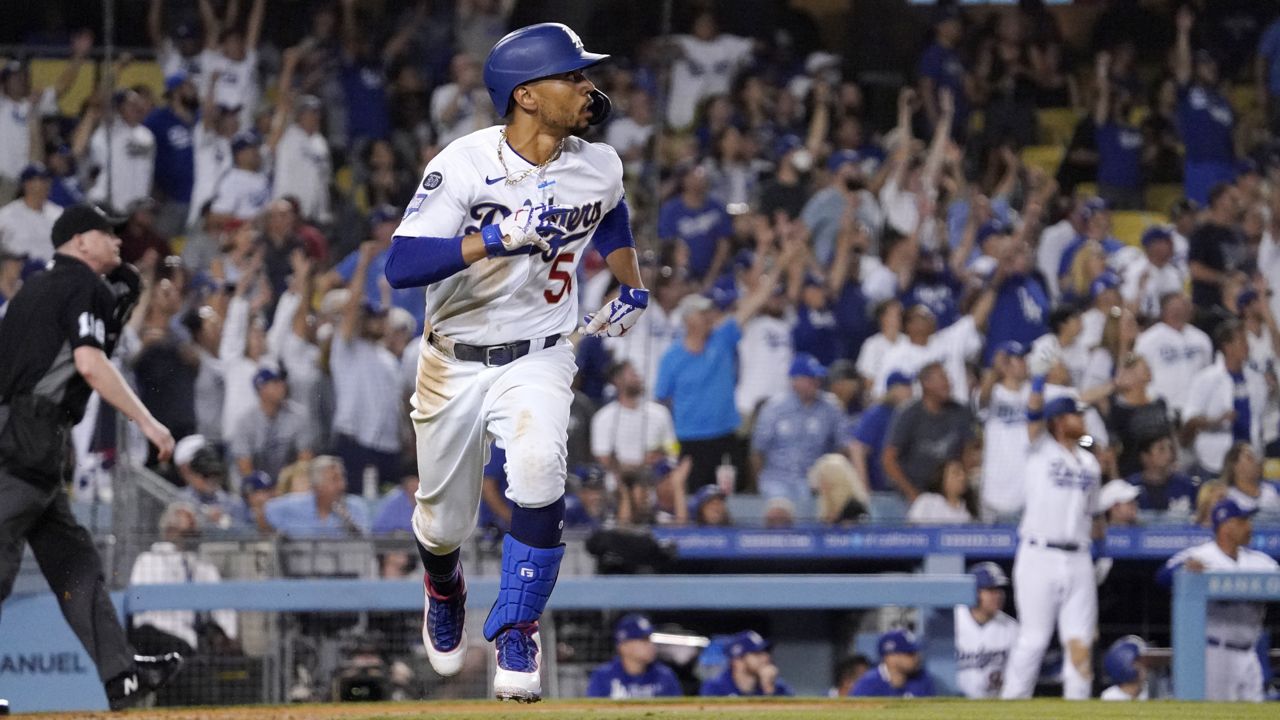 Los Angeles Dodgers' Mookie Betts runs to first after hitting a solo home run during the seventh inning of a baseball game against the Philadelphia Phillies Tuesday, June 15, 2021, in Los Angeles. (AP Photo/Mark J. Terrill)