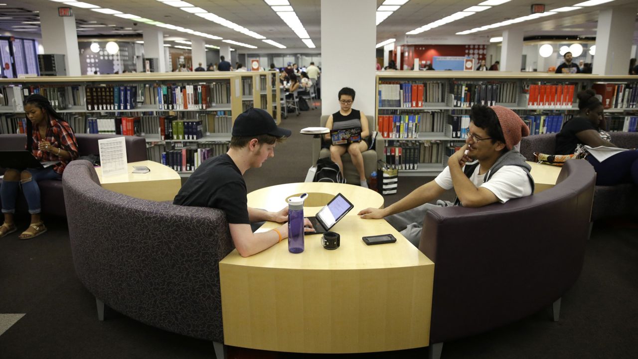Students Sean Aitchison, left, and Alex Aguilar study for their final exams at the newly-renovated Oviatt Library on the Cal State Northridge campus in Los Angeles on Thursday, May 12, 2016. (AP Photo/Jae C. Hong)