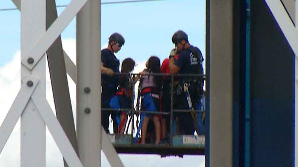 Orlando Fire Department personnel helping riders off "The Screamer" at Fun Spot in Orlando on Saturday, June 15, 2019. (Vincent Early/Spectrum News 13)