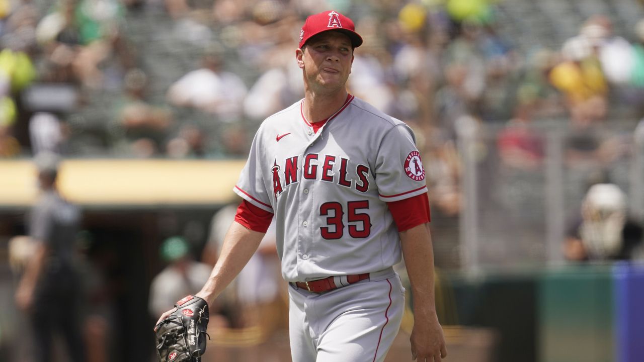 Los Angeles Angels relief pitcher Tony Watson walks to the dugout after being removed during the sixth inning of the team's baseball game against the Oakland Athletics on Wednesday, June 16, 2021, in Oakland, Calif. (AP Photo/Eric Risberg)