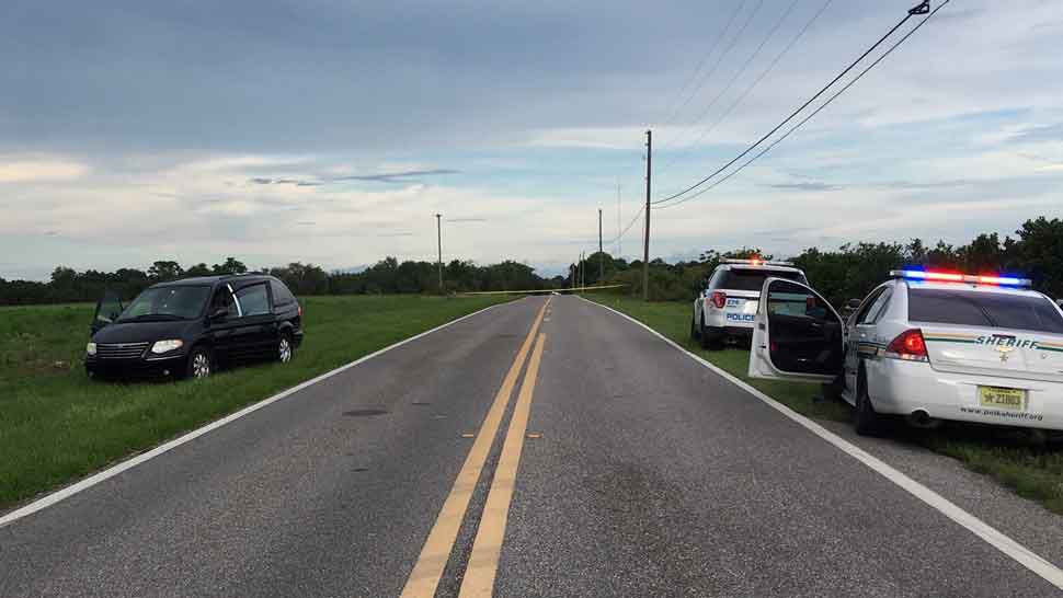 A Polk County Sheriff's Office cruiser is parked on one side of Carl Boozer Road in Haines City on Saturday, across from a van where a mother-daughter fight escalated into a deputy-involved shooting. (Polk County Sheriff's Office)