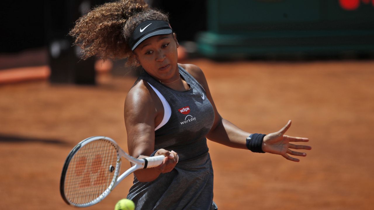 Naomi Osaka of Japan returns the ball to Jessica Pegula of the United States during their match at the Italian Open tennis tournament, in Rome, Wednesday, May 12, 2021. (AP Photo/Alessandra Tarantino) 