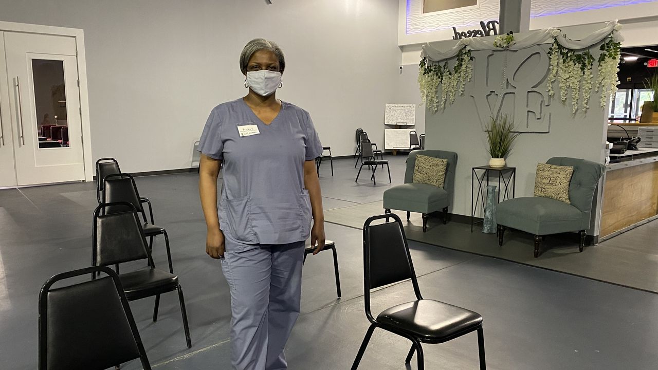 Ericka Sinclair stands in the observation area of a church vaccination clinic