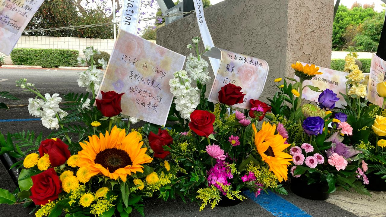 Flower bouquets are displayed as a memorial to victim's of Sunday's shooting as survivors and church leaders join in prayer and thank community members for their support nearly a week after a deadly shooting at a Taiwanese American church congregation Saturday, May 21, 2022, in Laguna Woods, Calif. (AP Photo/Amy Taxin)