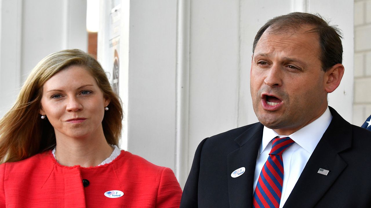 Rep. Andy Barr, R-Ky., right, and his wife Carol speak with reporters outside his polling place in Lexington, Ky., Tuesday, Nov. 6, 2018. (AP Photo/Timothy D. Easley)