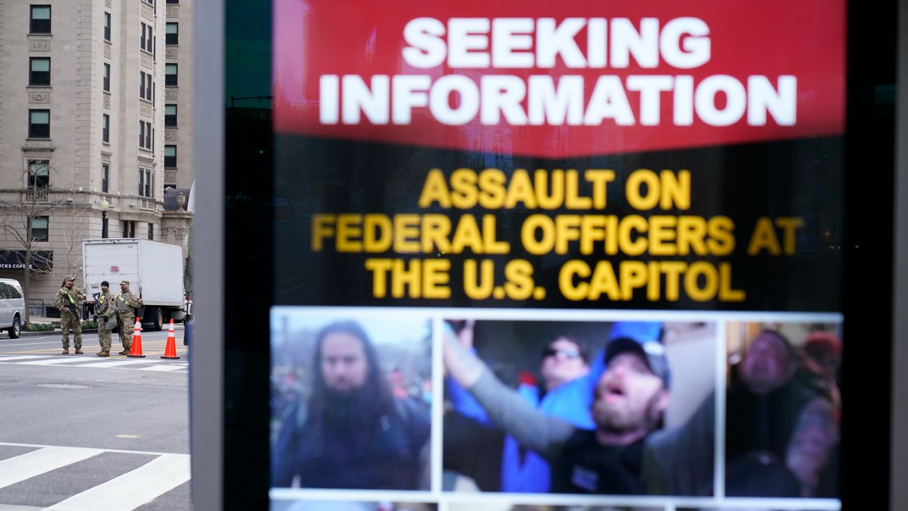 In this file photo from Jan. 17, 2021, a sign seeking information on persons involved with the deadly U.S. Capitol assault on Jan. 6 is displayed on a street in Washington. (AP photo/David Goldman)