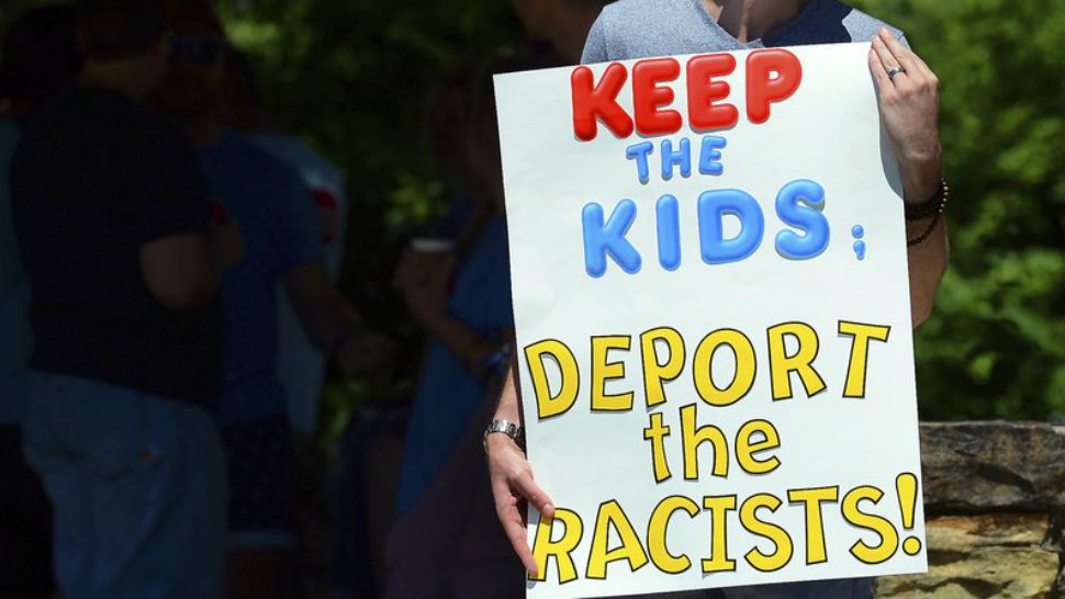 FILE - In this June 15, 2018 file photo, Chris Olson, of Lake Wallenpaupack, Pa., holds a sign outside Lackawanna College where U.S. Attorney Jeff Sessions spoke on immigration policy and law enforcement actions, in Scranton, Pa. The Trump administration’s move to separate immigrant parents from their children on the U.S.-Mexico border has turned into a full-blown crisis in recent weeks, drawing denunciation from the United Nations, Roman Catholic bishops and countless humanitarian groups. (Butch Comegys/The Times-Tribune via AP, File)