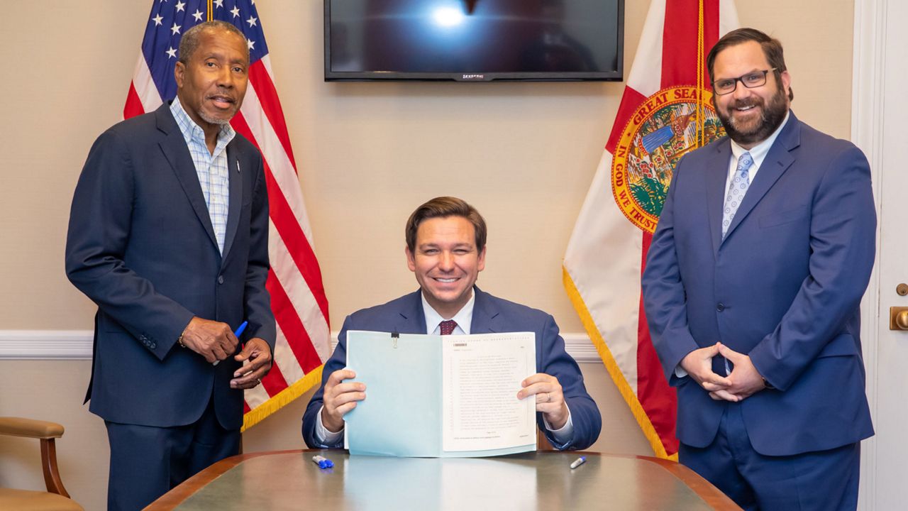 Left to right: Florida State Sen. Darryl Rouson, Gov. Ron DeSantis, and Rep. Chris Latvala following the Governor signing the bill "Jordan's Law" into law, Thursday, June 18, 2020. (Courtesy: Rep. Chris Latvala)