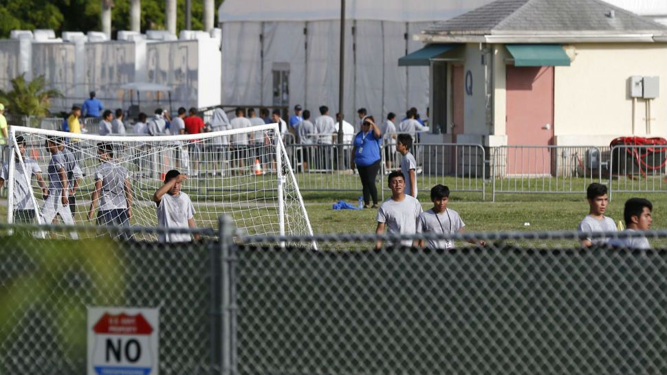 Immigrant children play outside a former Job Corps site that now houses them, Monday, June 18, 2018, in Homestead, Fla. It is not known if the children crossed the border as unaccompanied minors or were separated from family members. Wrenching scenes of migrant children being separated from their parents at the southern border are roiling campaigns ahead of midterm elections, emboldening Democrats on the often-fraught issue of immigration (AP Photo/Wilfredo Lee)