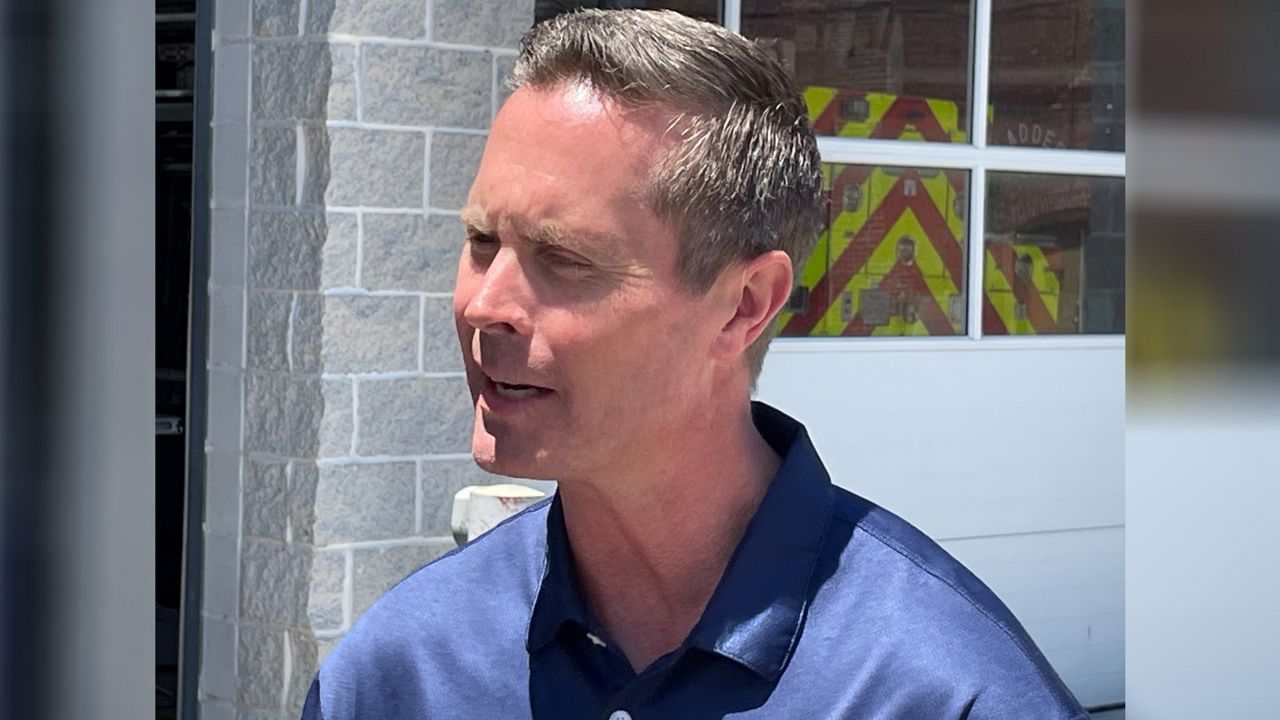 U.S. Rep. Rodney Davis talks to reporters Friday afternoon in Collinsville, Ill. Davis is locked in a primary contest against fellow U.S. Rep. Mary Miller. 