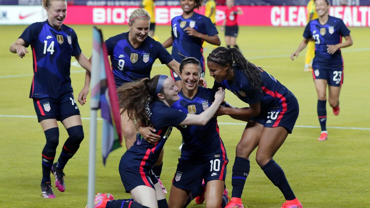 USA forward Carli Lloyd (10) is swarmed by her team mates after scoring a goal against Jamaica during the first half of their 2021 WNT Summer Series match Sunday, June 13, 2021, in Houston. (AP Photo/Michael Wyke)