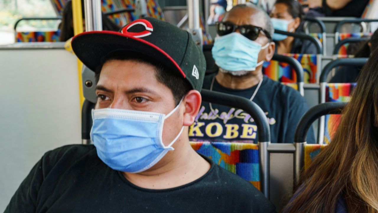 A Commuter wears a facemask while riding a Metro bus in downtown Los Angeles, Tuesday, April 26, 2022. (AP Photo/Damian Dovarganes)