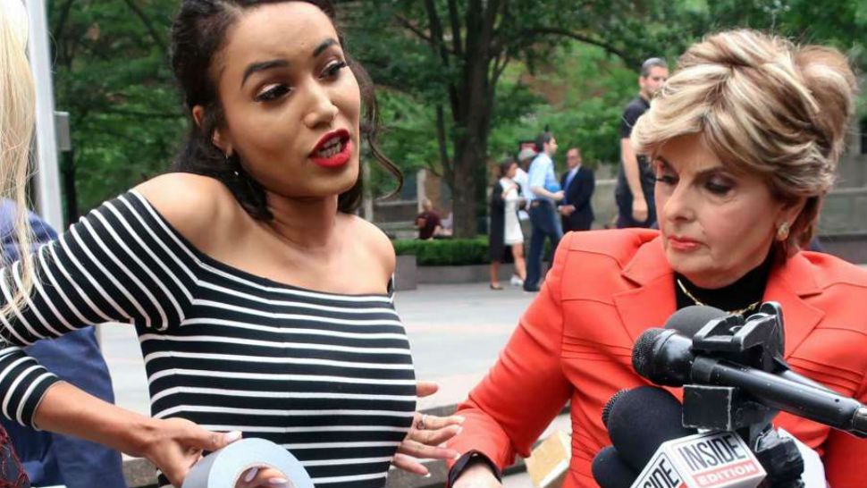 Former Houston Texans cheerleader Angelina Rosa demonstrates during a news conference outside NFL headquarters in New York, Friday, June 22, 2018, how she says she was forced to use duct tape to make her look skinnier during a game last year. Her attorney Gloria Allred, right, looks on. Rosa joins five other Texans cheerleaders in a lawsuit alleging the team failed to fully compensate them as required by law and subjected them to hostile work environment in which they were harassed, intimidated and forced to live in fear. (AP Photo/Ted Shaffrey)