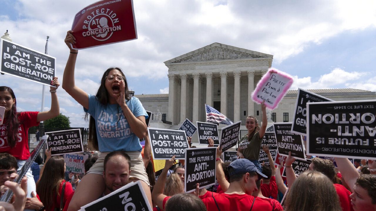 Anti-abortion protesters celebrate outside the Supreme Court in Washington, Friday, June 24, 2022. The Supreme Court has ended constitutional protections for abortion that had been in place nearly 50 years, a decision by its conservative majority to overturn the court's landmark abortion cases. (AP Photo/Jose Luis Magana)
