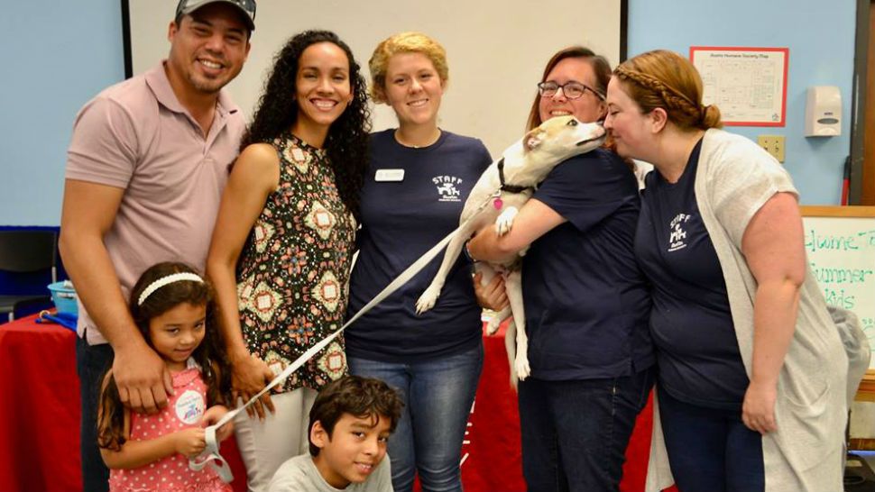 A family poses with Austin Humane Society workers after being reunited with their dog. Courtesy/Austin Humane Society