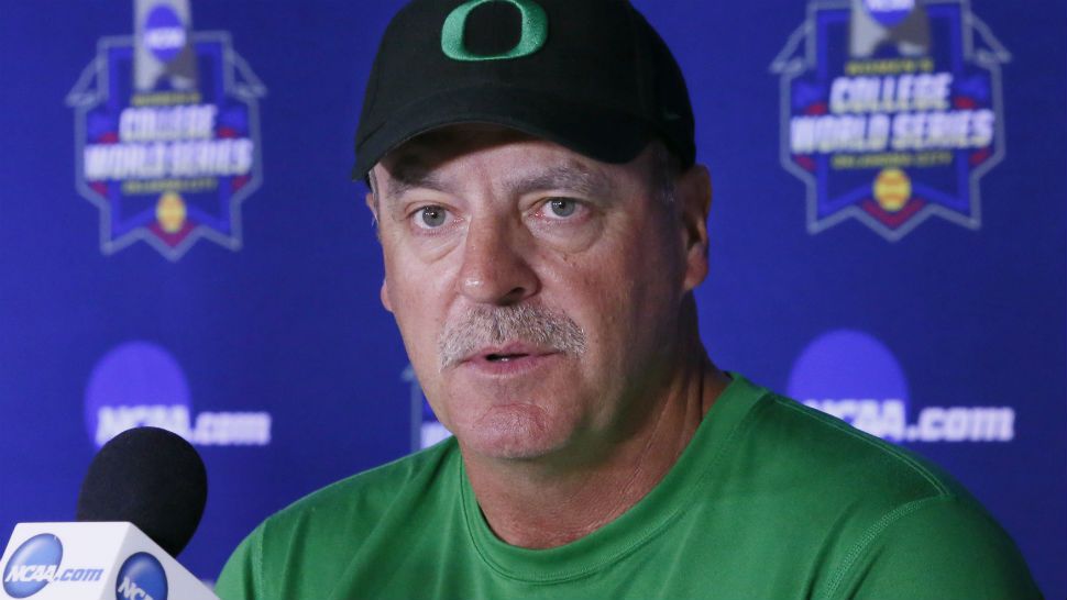 Oregon softball coach Mike White speaks at a press conference (AP Photo)