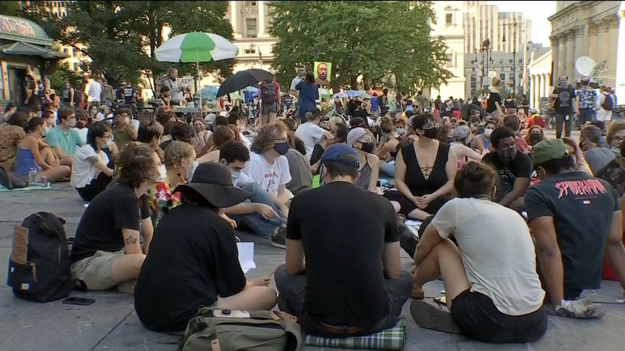 "Occupy City Hall" protesters sitting in the park outside City Hall in lower Manhattan