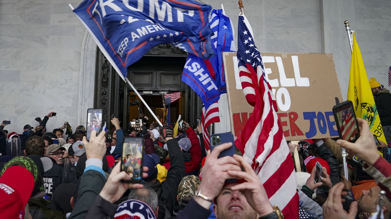 Trump supporters gather outside the Capitol in Washington on Jan. 6, 2021. (AP Photo/John Minchillo)