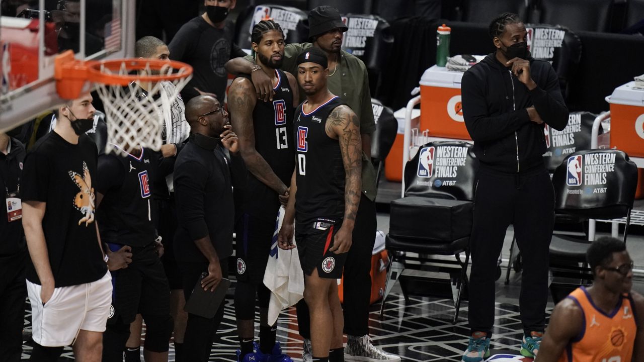 Los Angeles Clippers players watch action in the final seconds of Game 6 of the NBA basketball Western Conference Finals against the Phoenix Suns Wednesday, June 30, 2021, in Los Angeles. The Suns won 130-103. (AP Photo/Jae C. Hong)