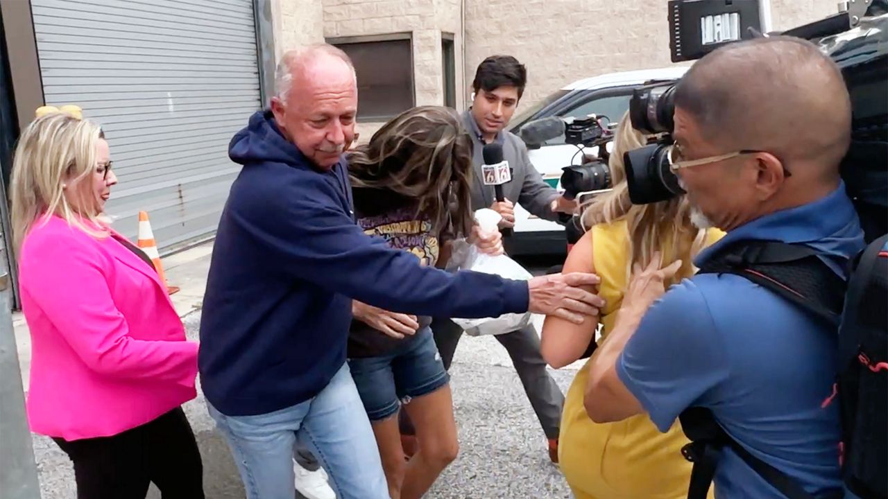 Media surrounds Robin Severance Lopez (located toward the back wearing blue sneakers) as she is released from the Lake County Jail on bond. (Spectrum News 13/Nick Allen)