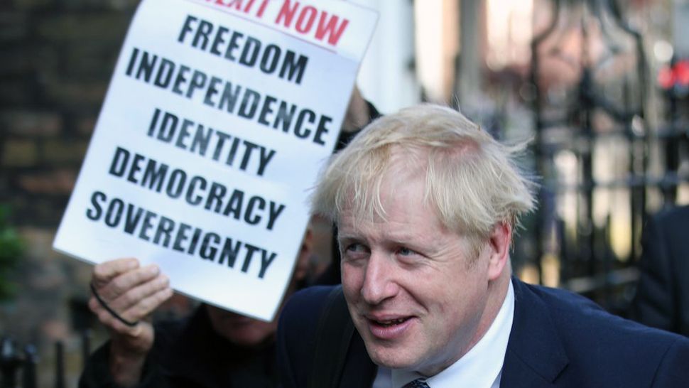 Conservative party leadership contender Boris Johnson, is shadowed by a Brexit demonstrator, as he arrives at his office in central London, Tuesday July 23, 2019. Britain’s governing Conservative Party is set to reveal the name of the country’s next prime minister later Tuesday, with Brexit champion Boris Johnson widely considered to be favourite to get the job against fellow contender Jeremy Hunt. (Yui Mok/PA via AP)