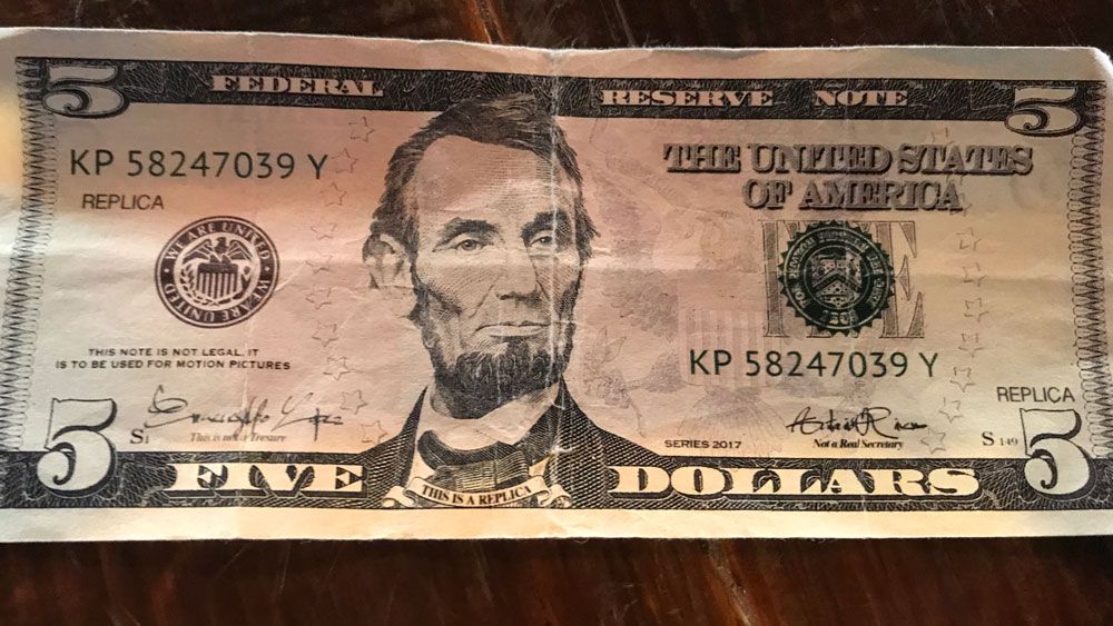 Businesses owners say this $5 bill feels like the real thing, but several things on the bill make it clear it's fake. (Greg Pallone, Spectrum News)
