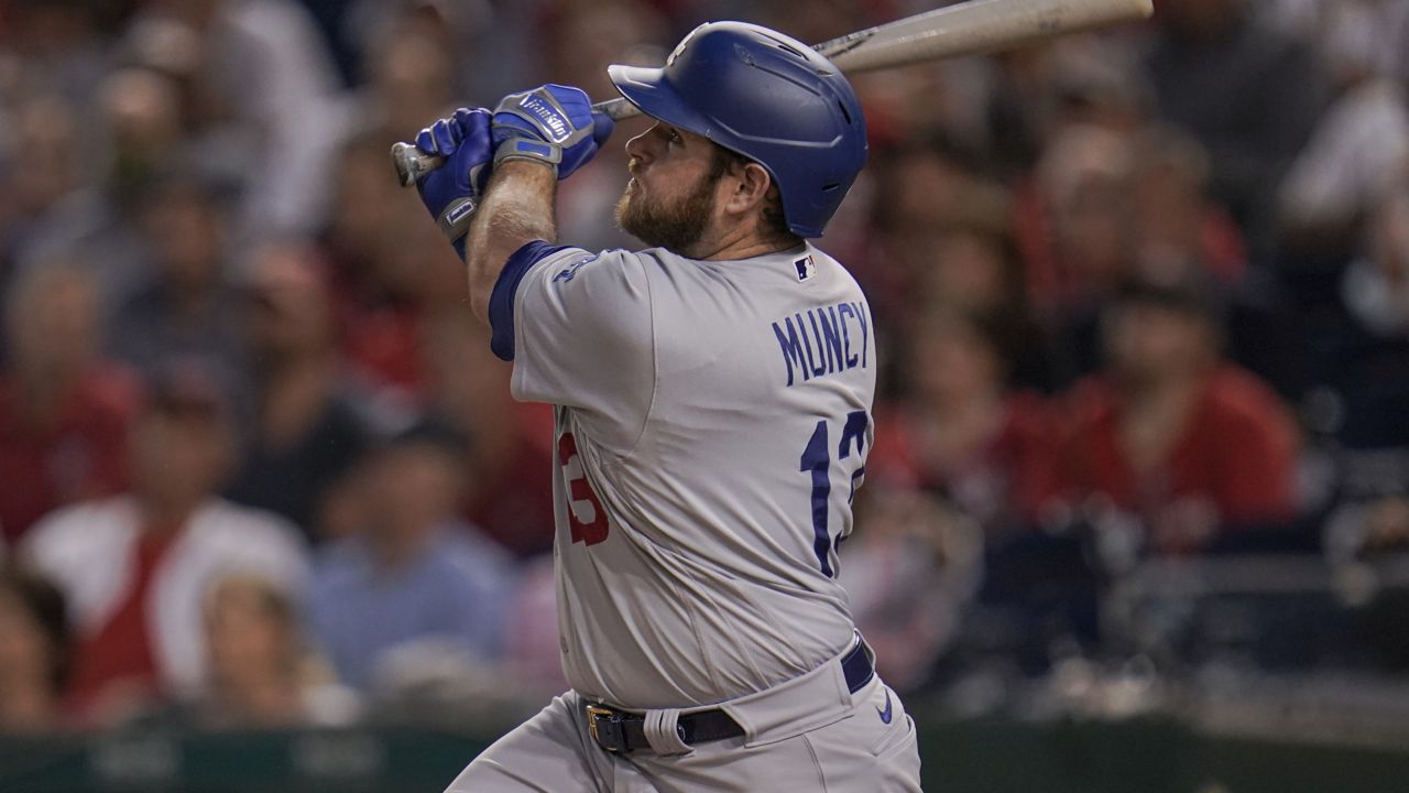 Los Angeles Dodgers' Max Muncy watches his ball while hitting a grand slam off Washington Nationals starting pitcher Patrick Corbin during the fifth inning of a baseball game, Thursday, July 1, 2021, in Washington. Dodgers' Steven Souza Jr., Chris Taylor and Justin Turner scored on the home run. (AP Photo/Julio Cortez)