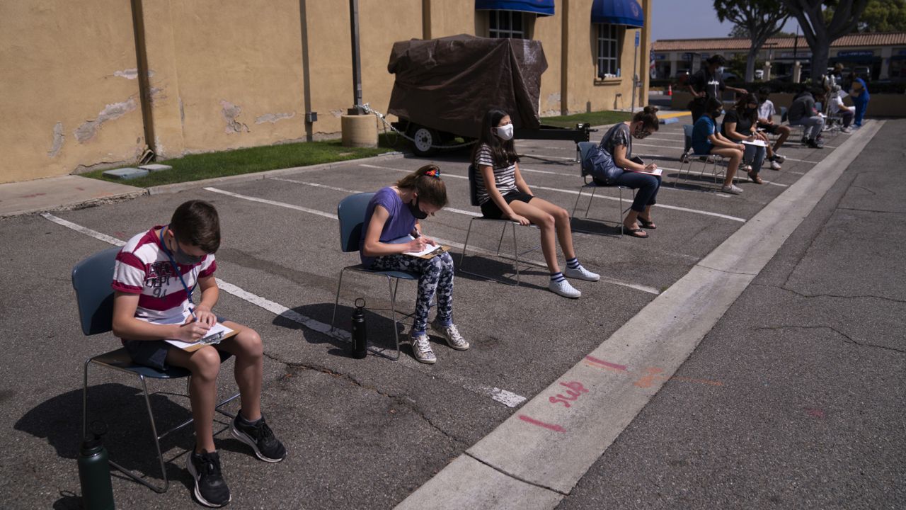 Children ages 12 to 15 wait to get their vitals checked before getting their Pfizer COVID-19 vaccine at Families Together of Orange County in Tustin, Calif. on May 13, 2021. (AP Photo/Jae C. Hong)