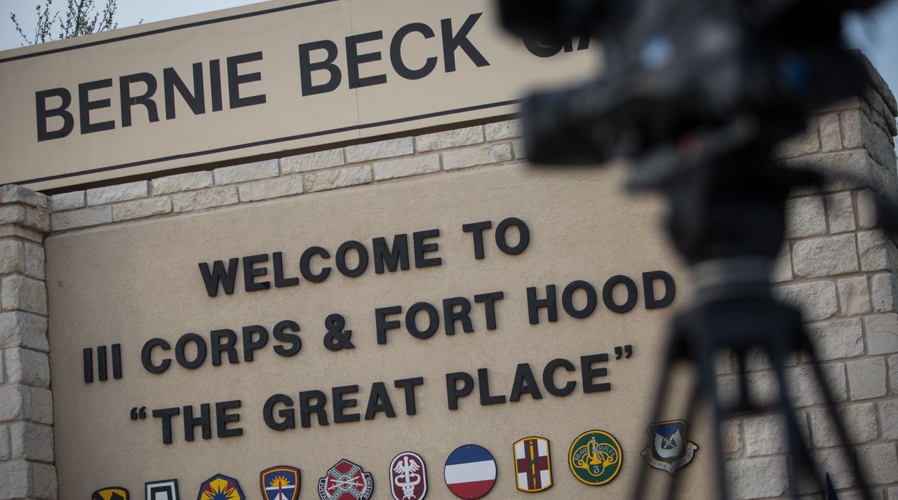 Members of the media wait outside of the Bernie Beck Gate, an entrance to the Fort Hood military base. (AP Photo/Tamir Kalifa)