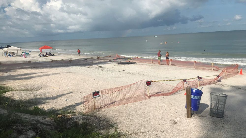 Jack Tenney erected this barrier around a portion of the beach in front of his home in Indian Rocks Beach, which he says a new state law allows. (David Jordan, Staff)