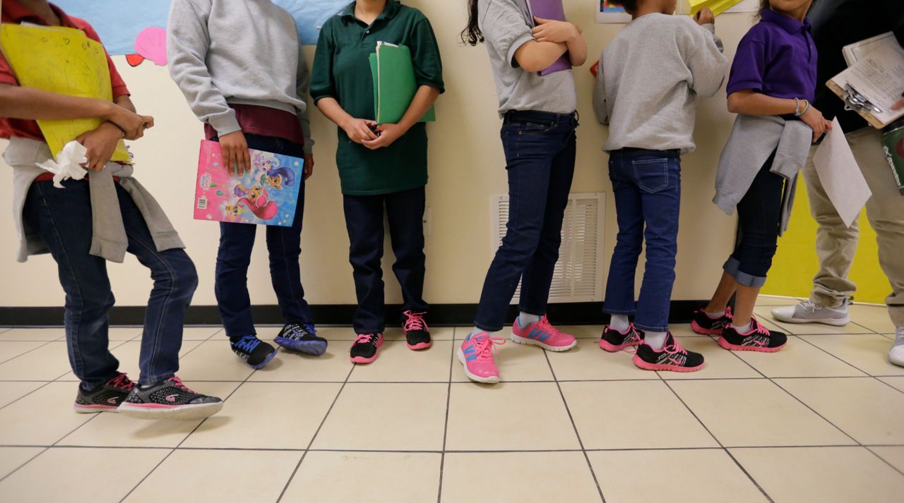 Migrant teens line up for a class at a "tender-age" facility for babies, children and teens, in Texas' Rio Grande Valley, Thursday, Aug. 29, 2019, in San Benito, Texas. (AP Photo/Eric Gay)