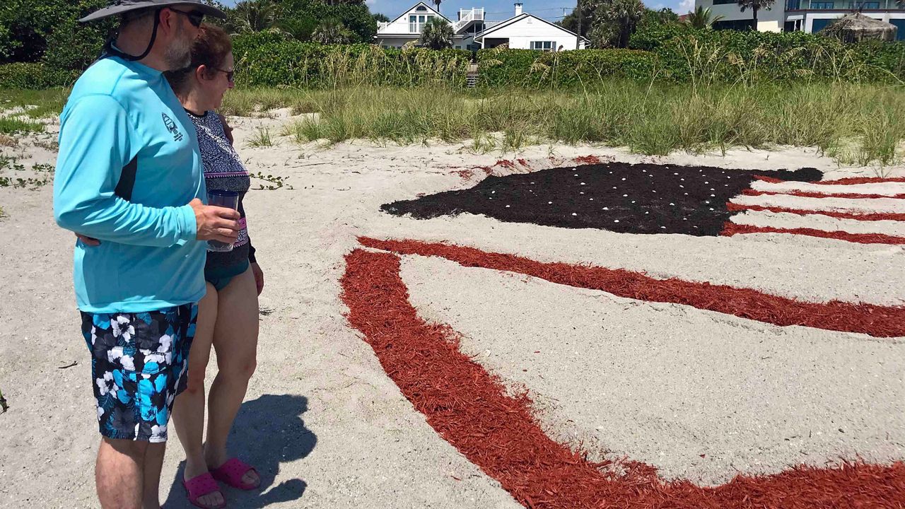 Eddie Gelles has created his American Flag display for the past four years at 4th Street South in Cocoa Beach. (Greg Pallone/Spectrum News 13)