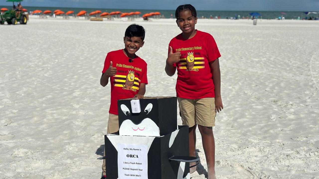 Aris Isaac, left, and Kaydyn Mack initially made the prototype robot for their school’s STEM fair. (Spectrum Bay News 9/Fallon Silcox)