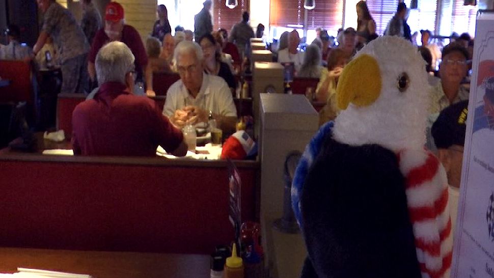 A group of veterans and people still in the armed forces took over a local restaurant thanks to the Space Coast Honor Flight group in Melbourne. (Spectrum News image)