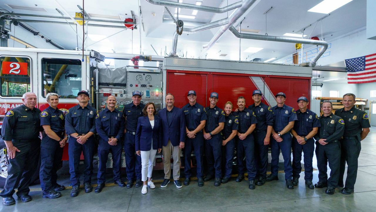 Vice President Kamala Harris, and second gentleman, Douglas Emhoff, middle, visit Fire Station No. 2 in Santa Monica, Calif., on Monday. (AP Photo/Damian Dovarganes)