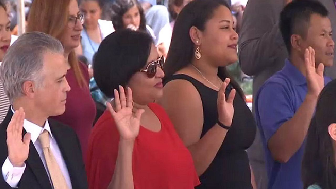 immigrants take the oath of citizenship