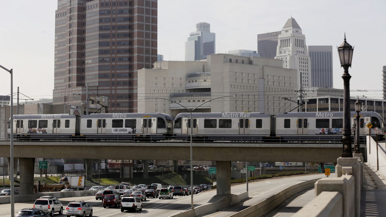A Metro Rail light train on the Gold Line travels over the 101 Santa Ana Freeway near Union Station in Los Angeles. (AP Photo/Damian Dovarganes)