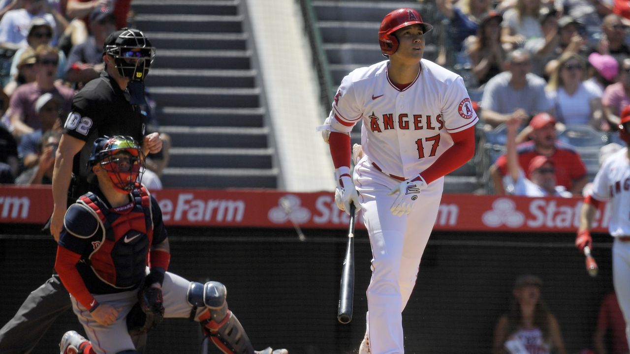 Los Angeles Angels' Shohei Ohtani, right, heads to first after hitting a solo home run as Boston Red Sox catcher Christian Vazquez, center, and home plate umpire Adam Beck watch during the fifth inning of a baseball game Wednesday, July 7, 2021, in Anaheim, Calif. (AP Photo/Mark J. Terrill)